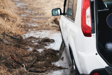 SUV car stuck in the mud close up.