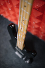 Close-up view of chords of cropped guitar. High angle view with selective focus of guitar's neck...