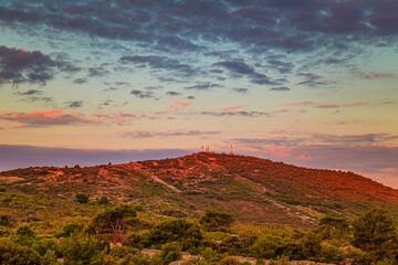 Hill with Our Lady Of Loreto Statue near The Primosten town at the colorful dawn of the day, Croatia, Europe.