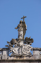 Fototapeta na wymiar Religious stone statue on top of one building in Tui, Pontevedra, Spain
