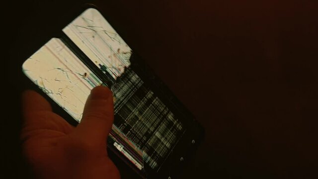 Broken display on your phone. White screen color with black, multi-colored stripes and cracks on the glass.