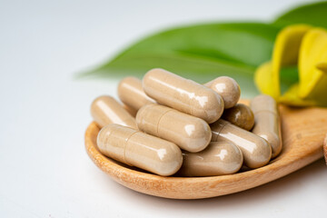 Fototapeta na wymiar Alternative medicine herbal organic capsule, mineral, drug with herbs leaf natural supplements for healthy good life.