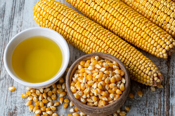 Corn essential oil bottle, corn groats, dry seeds and corncobs 