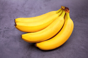 bunch of bananas on a cement background