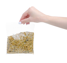 Dried herb chamomile in hand on white background isolation, top view