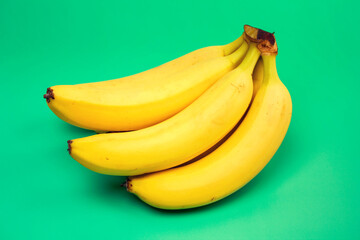 bunch of bananas on a green background