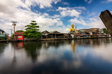 long exposure shot riverside village with big buddha statue background