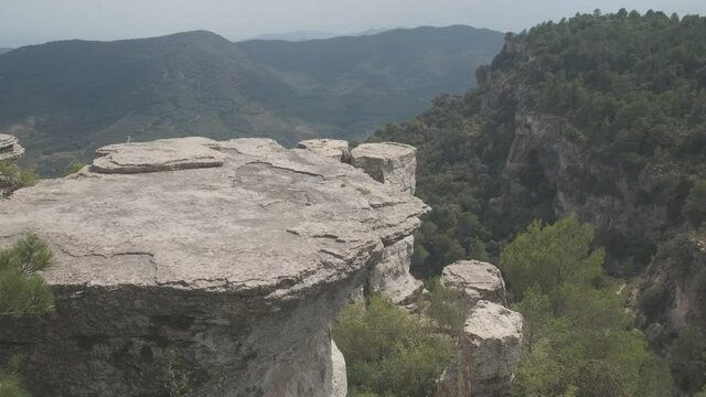 View of a mountain landscape in the Prades area in Catalonia with green and blue tones of the sky and clouds