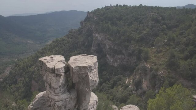 View of a mountain landscape in the Prades area in Catalonia with green and blue tones of the sky and clouds