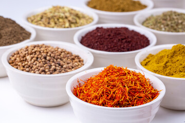 Colorful spices and herbs isolated on cooking background and design