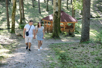 Boyfriend and girlfriend. Couple. In love. Forest Arboretum in Kudypy. Poland - Masuria - Warmia....