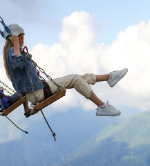 The girl took off on a swing into the clouds.