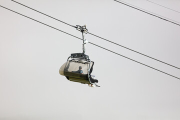 Cable car in the mountains against a background of clouds