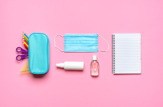 School supplies on a pink desk. Back to school pandemic requirements