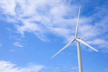Wind turbine against beautiful blue sky. Alternative energy source