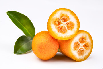 Top view of bunch of fresh kumquats in the organic food market. Some kumquats is cutted.
