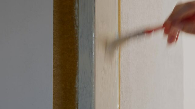 Man painting a door frame