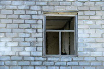 Old wooden window on a wall. Brick wall with window opening. Building a house.