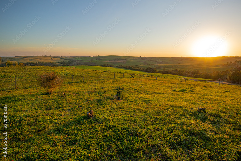 Wall mural Landscape Sunset on farm no trees