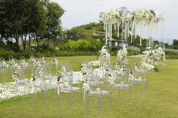 Wedding arch, chairs for guests, wedding accessories and decorations. Wedding ceremony. Beautiful wedding setup.
