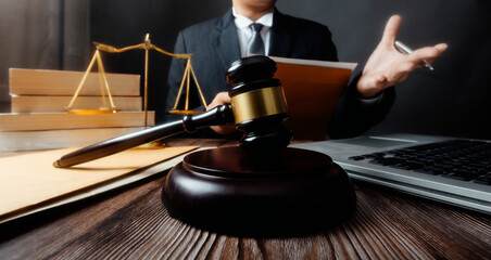 Business and lawyers discussing contract papers with brass scale on desk in office. Law, legal services, advice, justice and law concept picture with film grain effect