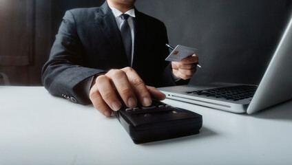 Businesswomen hands working with finances about cost and calculator and laptop with tablet, smartphone at office in morning light with film grain effect