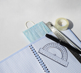 Notebook protractor ruler pencils pens scotch tape and medical masks. Study and work during a...