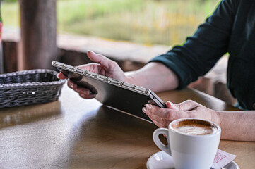 Customer order food and drink, using tablet in a restaurant. Digital menu.