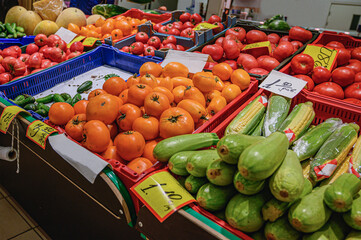 Fresh vegetables on farmers market, pint baskets of organic colorful vegetables on the counter at a farmers market.