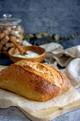 Loaf of sourdough craft bread on a dark background close-up, vertical background