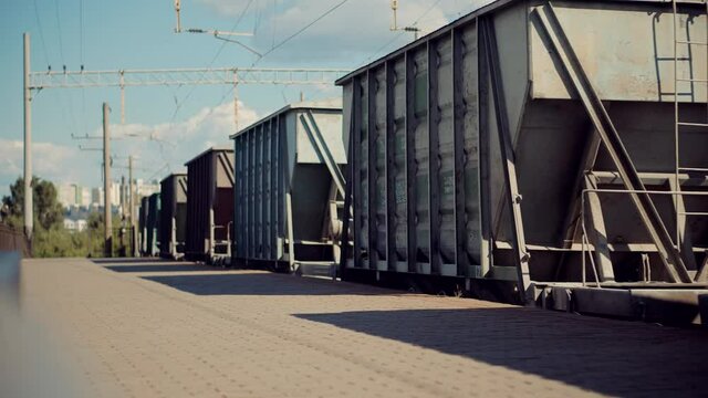 Electric Locomotive With Wagons Rides On Steel Railway.Heavy Industry Transportation Concept.Cargo Train Moving On Platform Staion.Kiev City Logictics.Freight Train Passing Through Passenger Station.