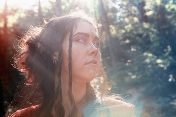 Fantasy. Portrait of a young brunette woman in the form of an elf, druid or fairy, looking away....