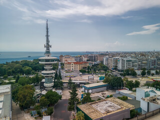 Thessaloniki, Greece aerial drone view of empty International trade TIF fair. Day south view panorama of HELEXPO premises without crowd, OTE Telecommunications Tower & White Tower landmark visible.