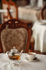 Tea Party with sweet cakes over table background in a charming classic restaurant