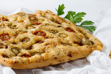 Traditional Italian focaccia with tomato and olives