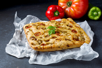 Traditional Italian focaccia with tomato and olives