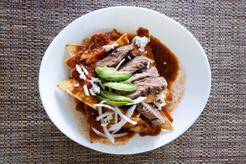 Top view of chilaquiles, authentic mexican breakfast