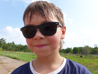 Smiling teenage boy in wearing sunglasses