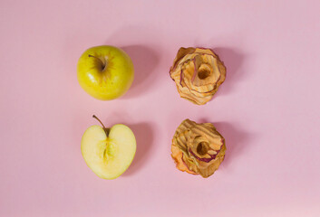 Natural apple chips on a pink background. Healthy vegan vegetarian fruit snacks. Organic products for wellness. Time to lose weight
