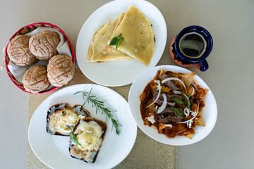 Delicious mexican breakfast dishes, chilaquiles, crepes and egg toast