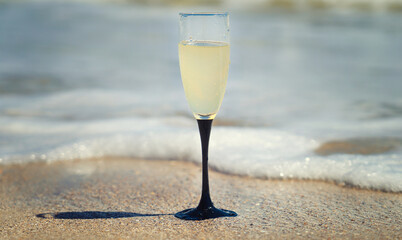 A glass of champagne by the sea.