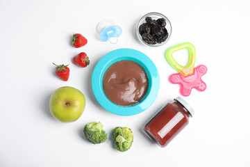 Flat lay composition with healthy baby food, ingredients and accessories on white background