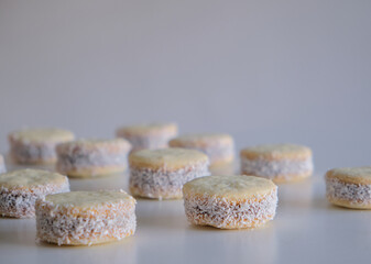 cornstarch alfajores filled with dulce de leche and sprinkled with grated coconut