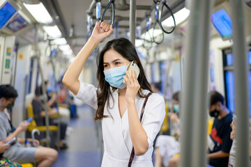 Fototapeta premium An young woman is wearing protective mask in metro , covid-19 protection , safety travel , new normal , social distancing , safety transportation , travel under pandemic concept .