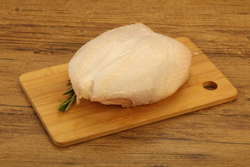 Raw whole chicken breast with skin