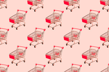 Shopping cart seamless pattern on pastel pink background.