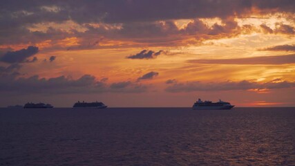 Six cruise ships on anchor in the middle of the ocean - sunset time