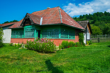 Fototapeta na wymiar Traditional old wooden house and garden in Maramures, Romania