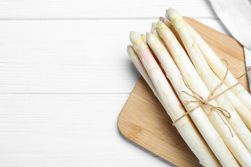 Fresh white asparagus on wooden table, top view. Space for text