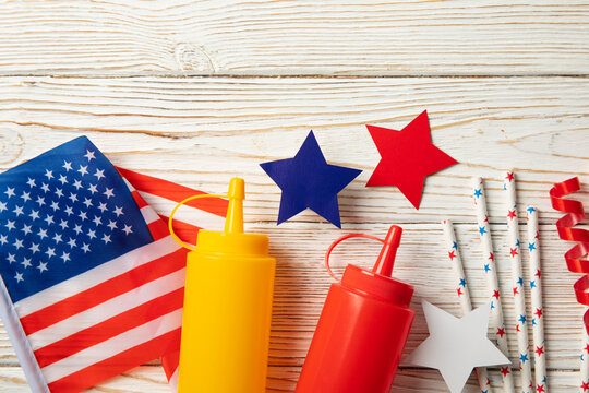 Composition with american flag, bottles for sauce and color stars on wooden background - Powered by Adobe